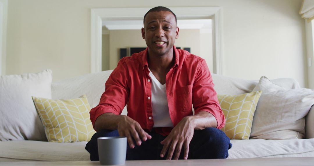 Smiling Man Having Video Call Seated on Cozy Sofa