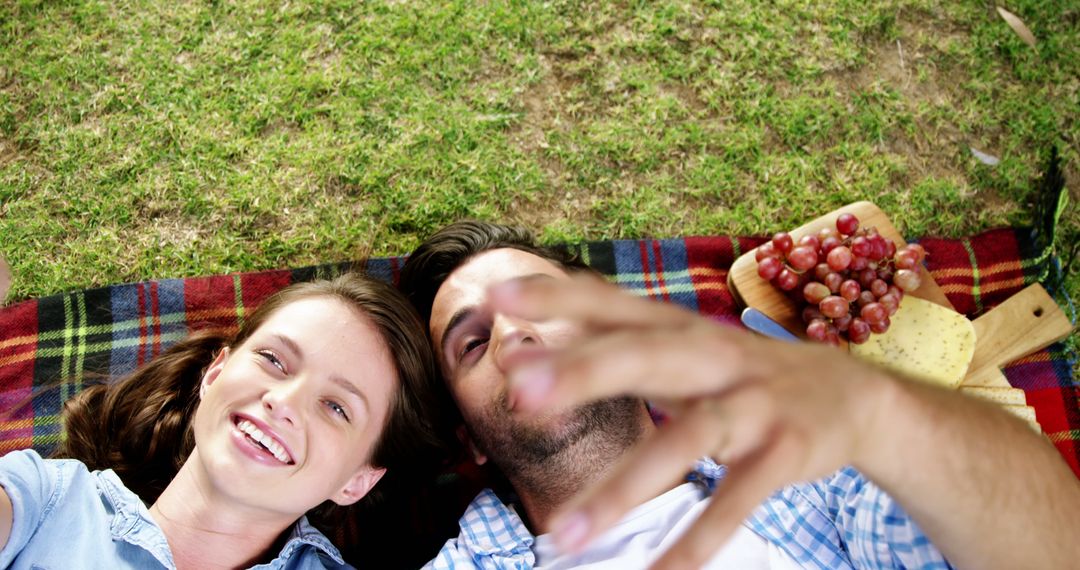 Couple Enjoys Picnic on a Sunny Day Capturing a Selfie