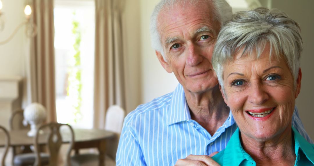 Smiling Senior Couple Posing Together in Living Room