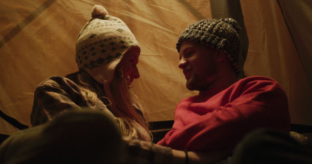 Caucasian Couple Relaxing Inside Tent During Camping Trip