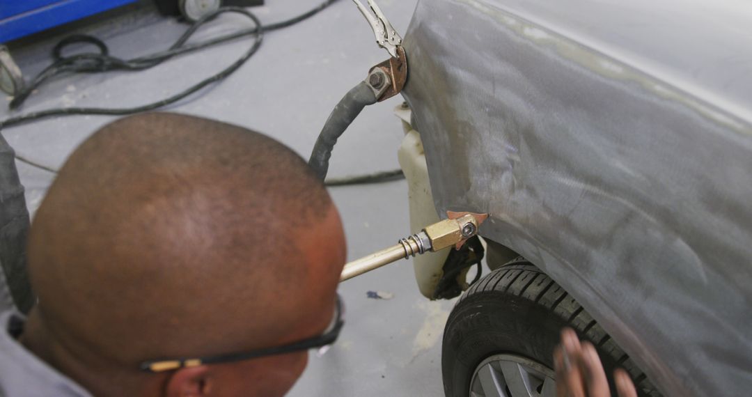 Mechanic Repairing Car Fender in Auto Body Shop Using Welding Torch - Free Images, Stock Photos and Pictures on Pikwizard.com