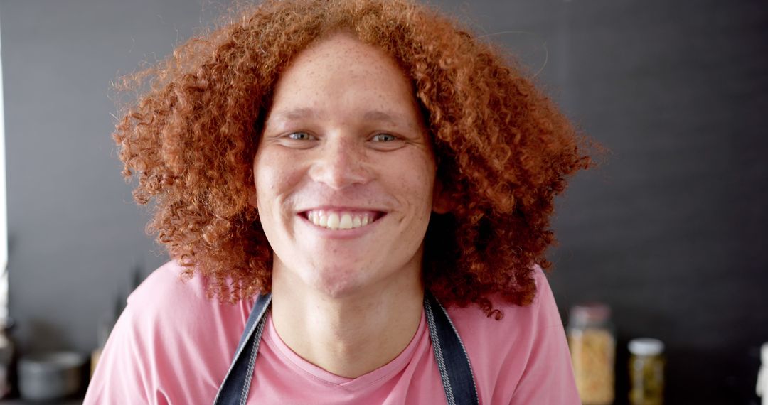 Portrait of happy biracial man with red curly hair smiling in sunny kitchen - Free Images, Stock Photos and Pictures on Pikwizard.com