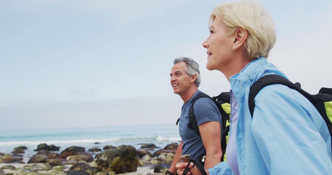 Senior Couple Hiking on Rocky Seaside Trail - Free Images, Stock Photos and Pictures on Pikwizard.com