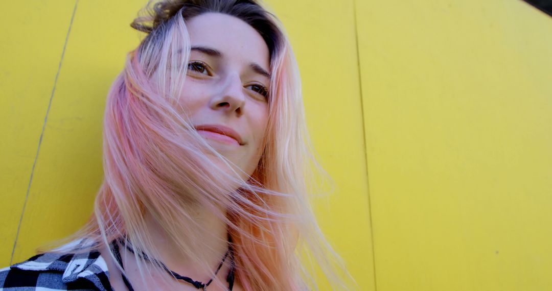 Confident Young Woman with Colorful Hair Smiling Against Yellow Background - Free Images, Stock Photos and Pictures on Pikwizard.com