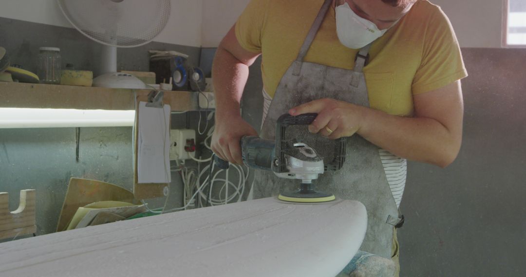 Craftsman Shaping Surfboard in Workshop with Focused Precision - Free Images, Stock Photos and Pictures on Pikwizard.com