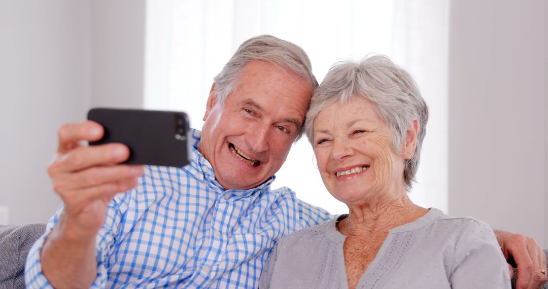 Senior couple taking selfie at home  - Free Images, Stock Photos and Pictures on Pikwizard.com