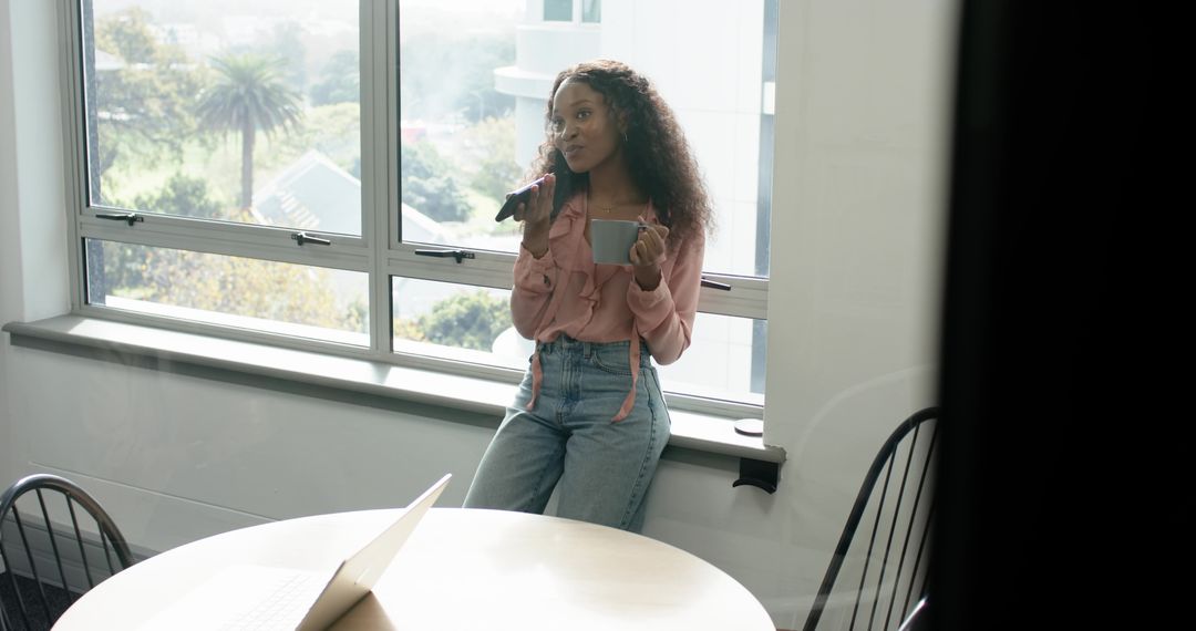Young Woman Relaxed with Microphone in Sunlit Office Space