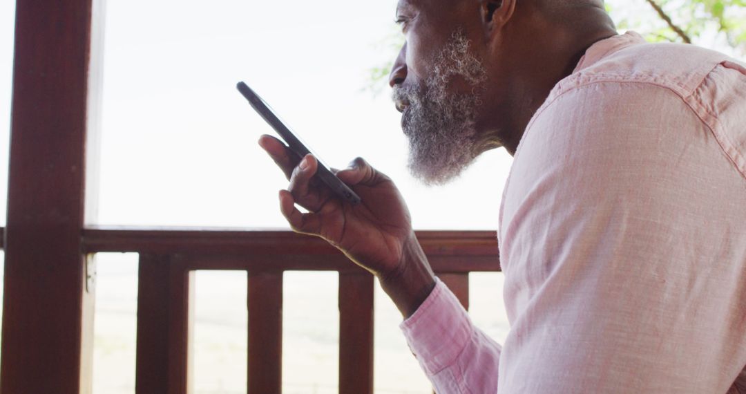 Senior man recording voice message on smartphone outdoors - Free Images, Stock Photos and Pictures on Pikwizard.com