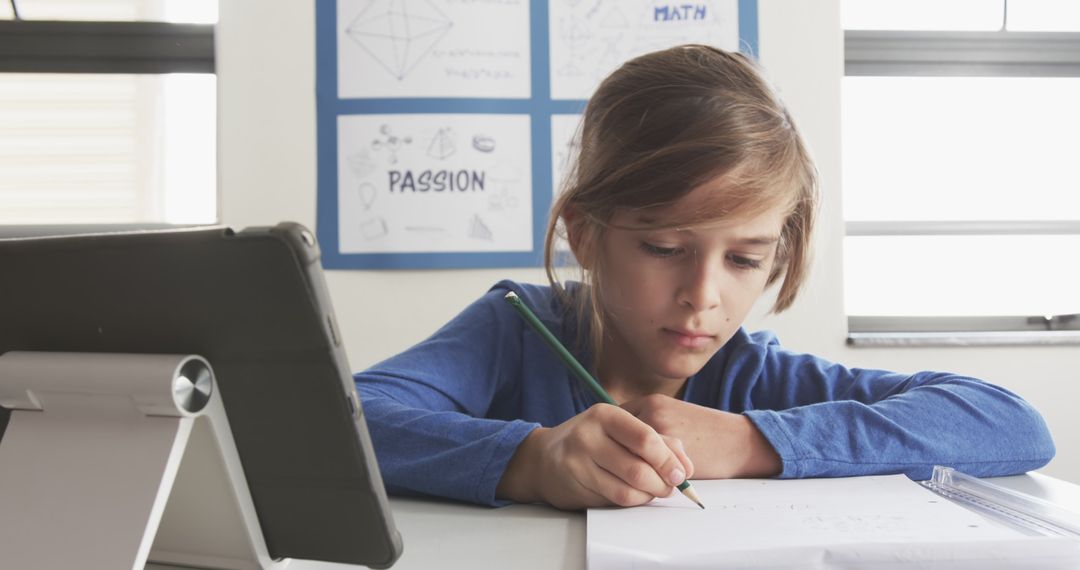 Focused Boy Learning through Writing with Tablet at Home