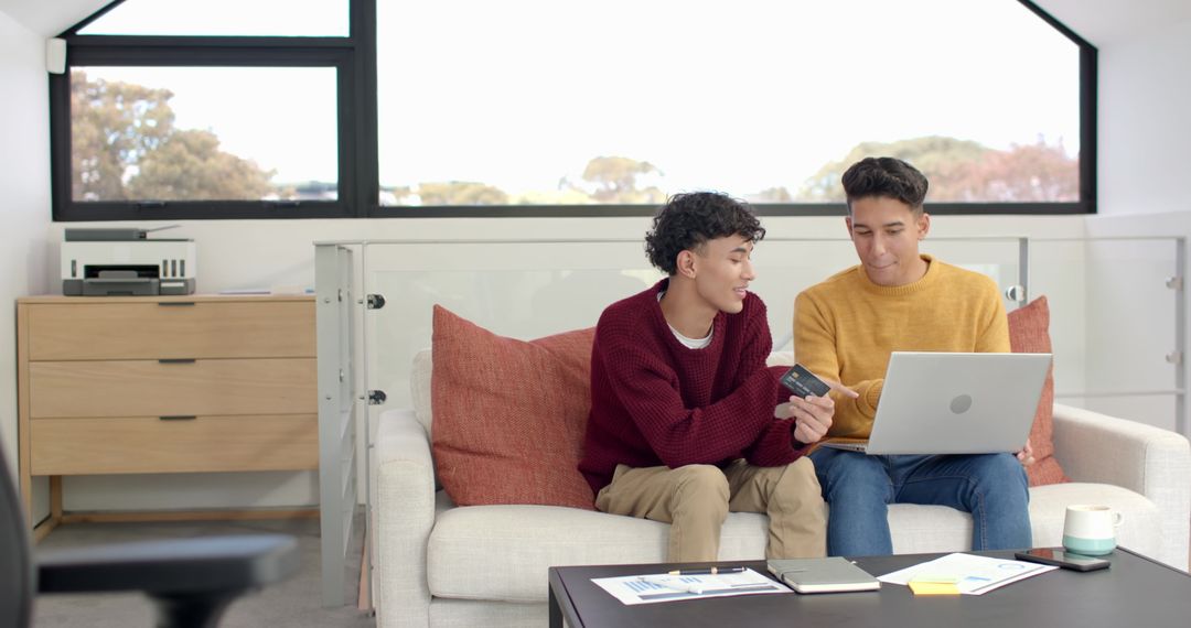 Friends Collaborating on Financial Analysis at Home with Laptop