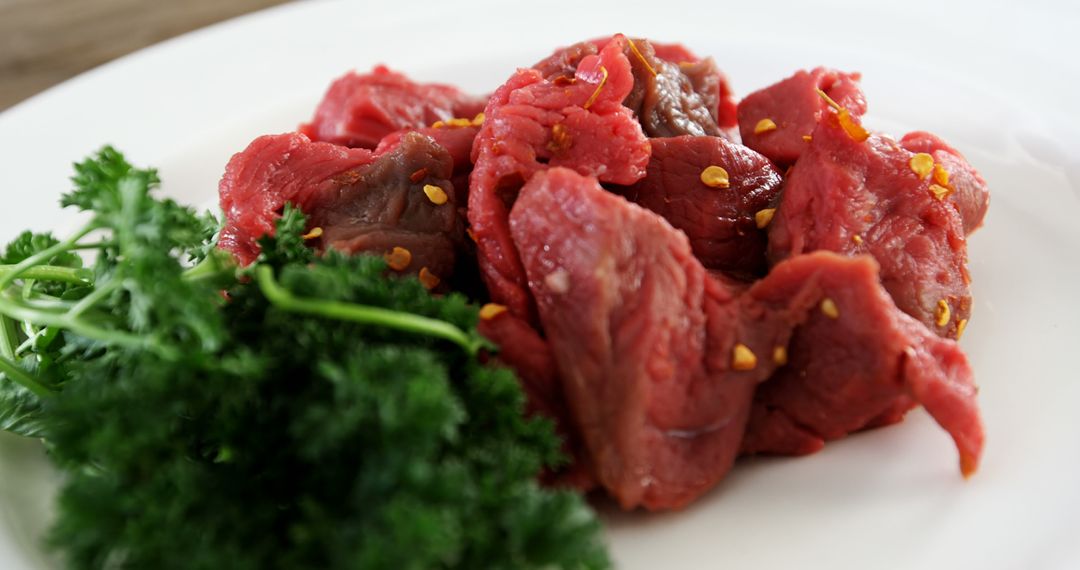 Close-up of Fresh Sliced Beef with Parsley on White Plate - Free Images, Stock Photos and Pictures on Pikwizard.com