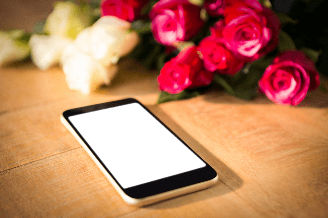Transparent Display Mobile Phone with Flowers on Wooden Table