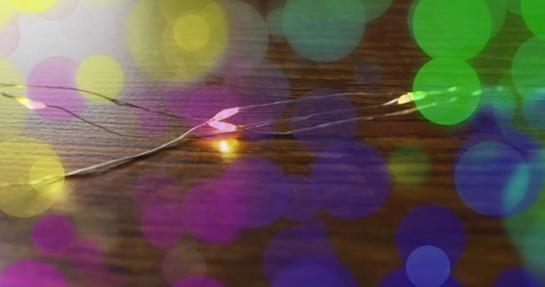 Vibrant Bokeh Lights with String Lights on Wooden Surface