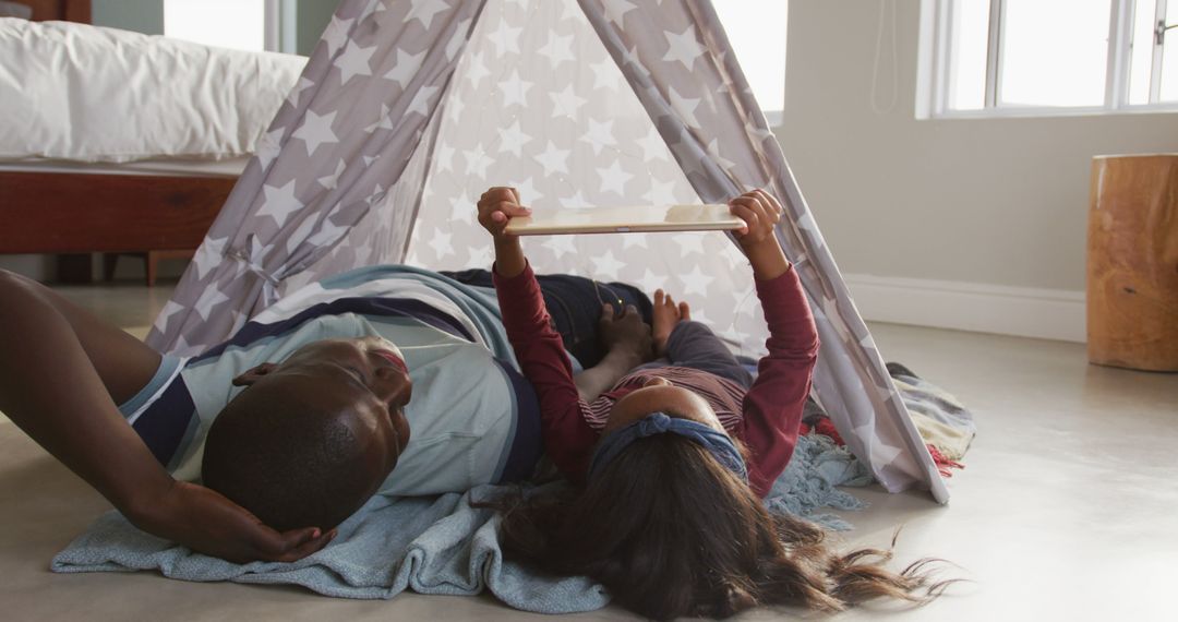 Father and Daughter Reading Inside a Cozy Indoor Tent - Free Images, Stock Photos and Pictures on Pikwizard.com