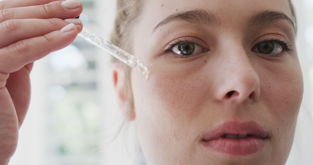 Close Up of Woman Applying Serum with Dropper for Skincare - Free Images, Stock Photos and Pictures on Pikwizard.com