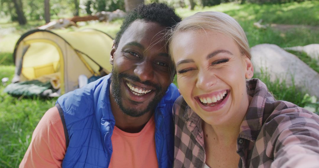Happy Diverse Couple Camping smiling in Natural Setting