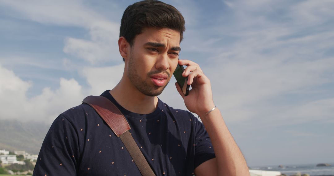 Young Man Talking on Phone Outdoors on Sunny Day - Free Images, Stock Photos and Pictures on Pikwizard.com