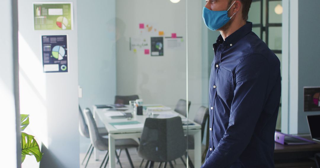 Businessman Wearing Face Mask in Modern Office - Free Images, Stock Photos and Pictures on Pikwizard.com