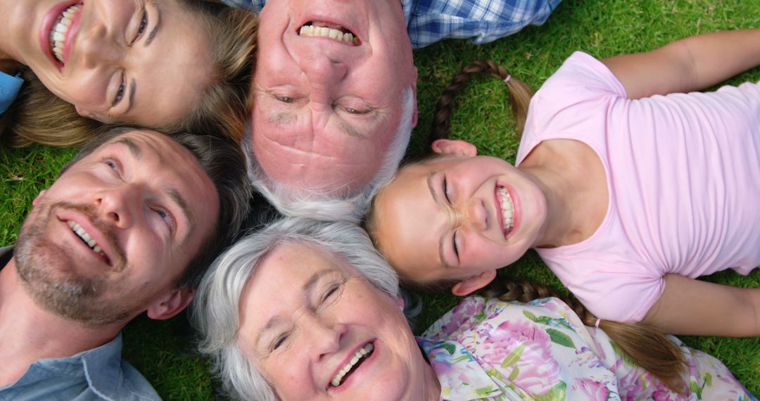 Happy Multi-Generational Family Lying on Grass Outdoors - Free Images, Stock Photos and Pictures on Pikwizard.com