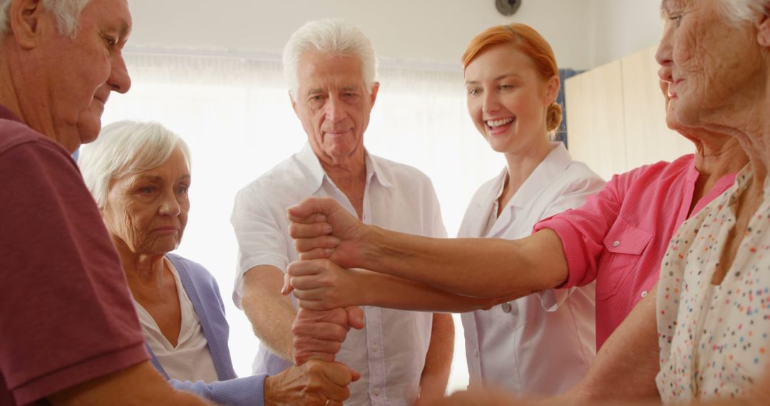 Group of senior people and therapist putting their fist together while exercising  - Free Images, Stock Photos and Pictures on Pikwizard.com