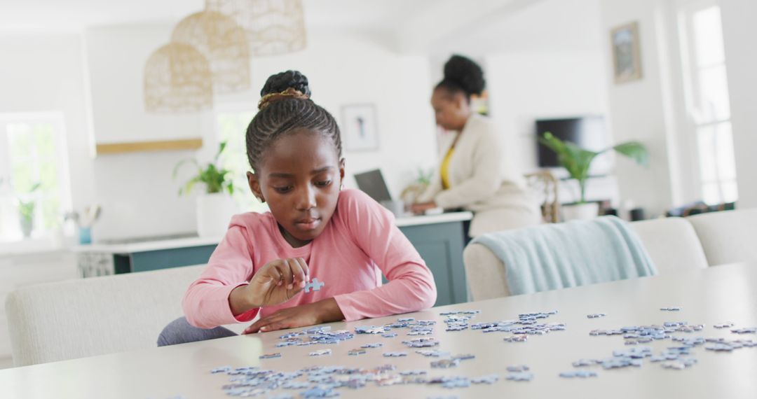 Young girl focusing on completing a puzzle - Free Images, Stock Photos and Pictures on Pikwizard.com