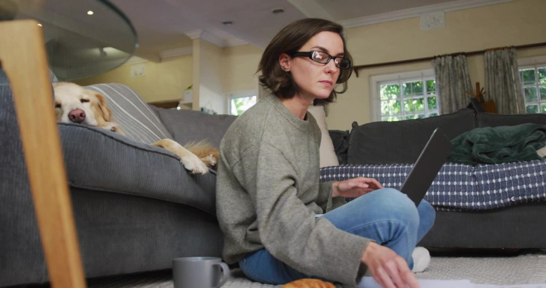 Woman Working at Home with Dog on Sofa, Cozy and Relaxed Atmosphere