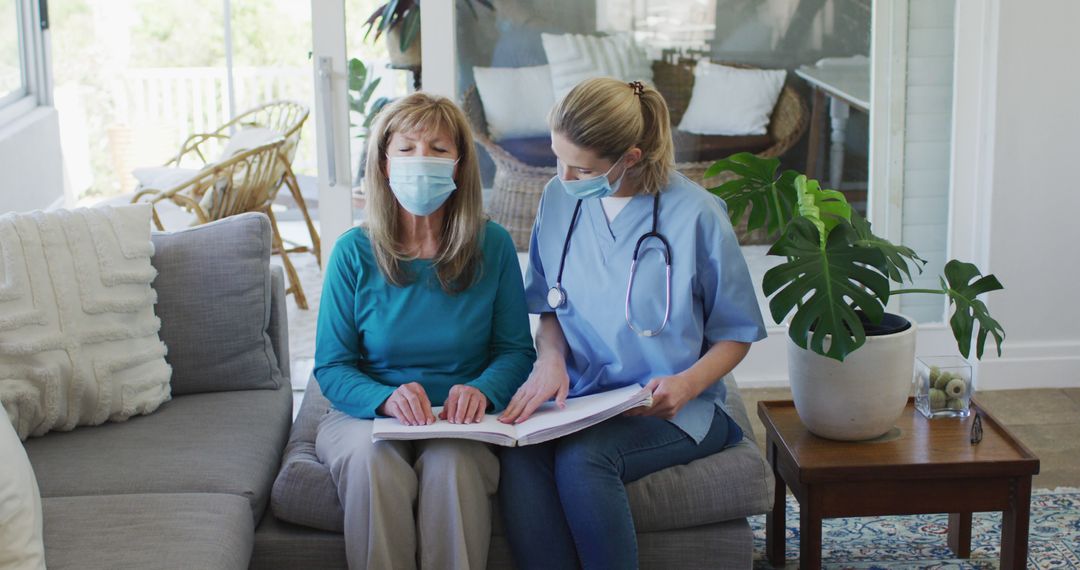 Nurse Assisting Senior Woman with Paperwork at Home During Pandemic - Free Images, Stock Photos and Pictures on Pikwizard.com