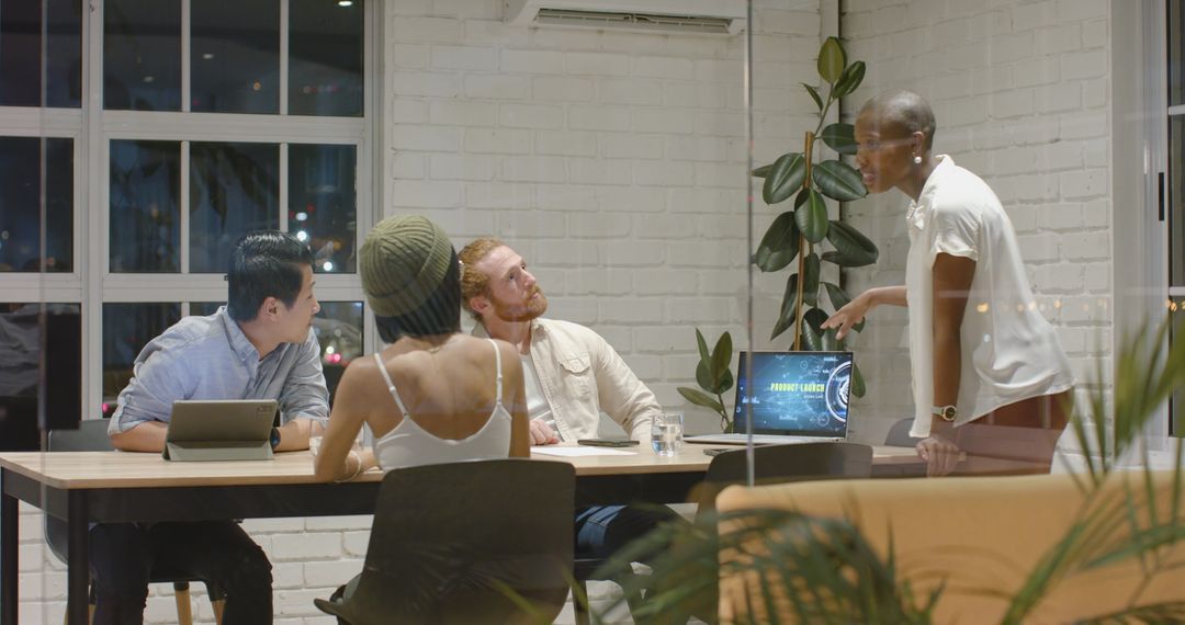 Diverse Team Collaborating in Modern Office Setting, Discussing Strategy