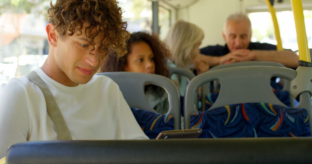 Biracial man sitting in city bus using smartphone - Free Images, Stock Photos and Pictures on Pikwizard.com