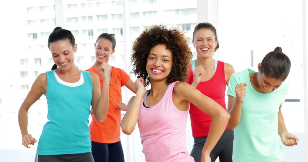 Diverse group of women enjoying energetic dance fitness class indoors - Free Images, Stock Photos and Pictures on Pikwizard.com