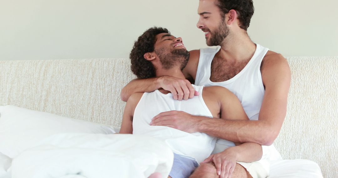 Joyful Multiethnic Couple Embracing in Bedroom with Copy Space