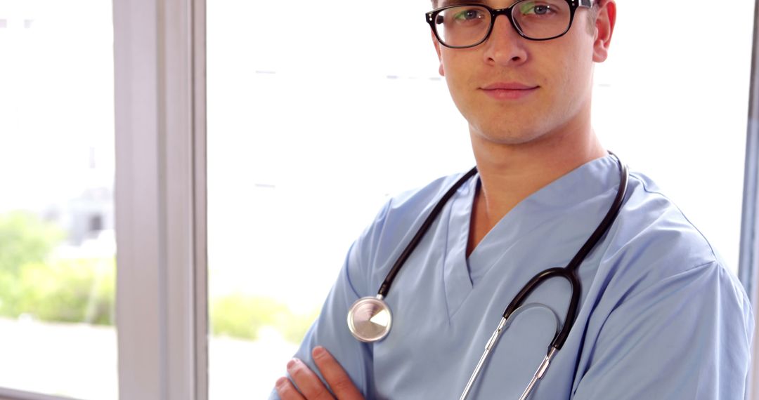 Confident Male Doctor in Scrubs with Stethoscope - Free Images, Stock Photos and Pictures on Pikwizard.com