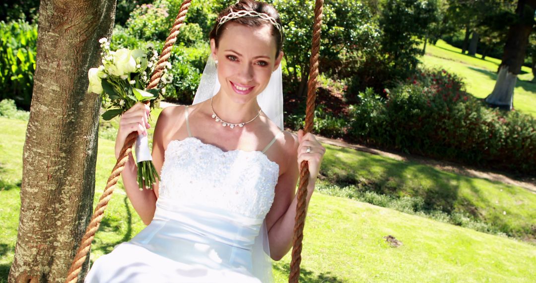 Radiant Bride Sitting on Rope Swing in Garden - Free Images, Stock Photos and Pictures on Pikwizard.com