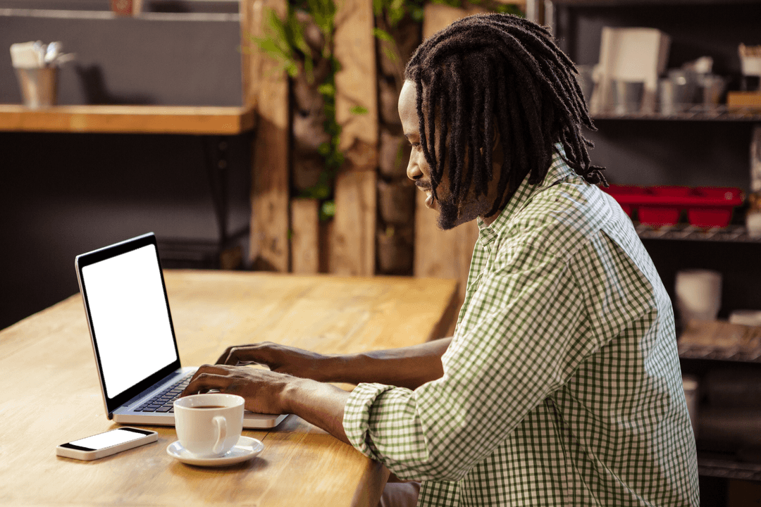 Transparent Man Working on Laptop in Cozy Cafe