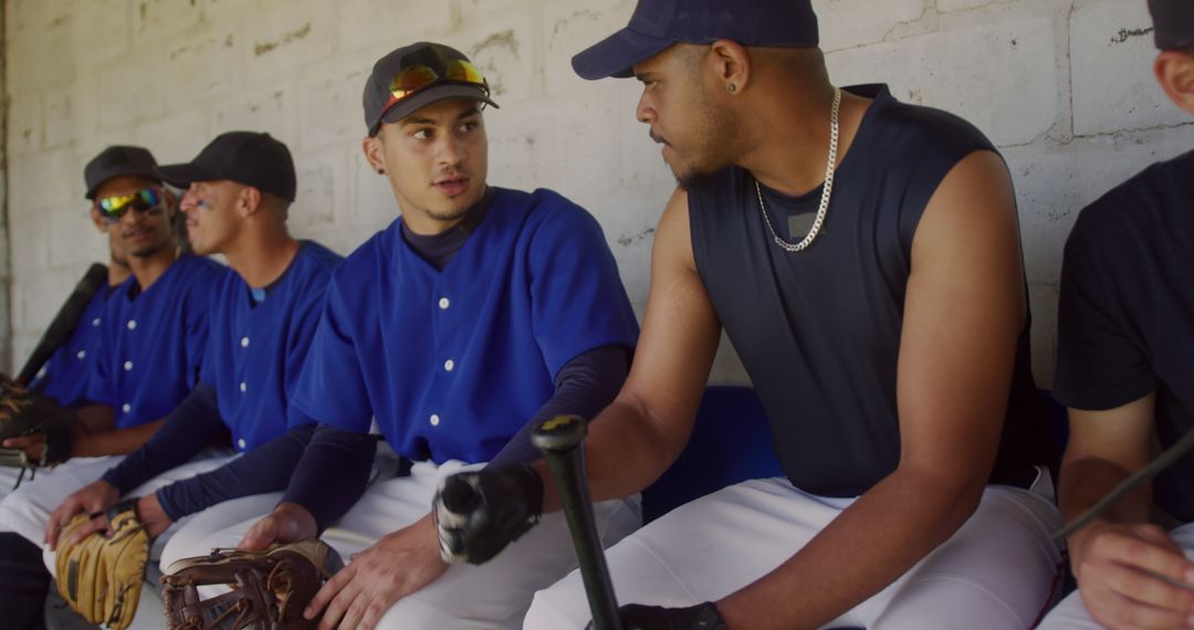 Baseball Team Members Sitting and Talking in Dugout - Free Images, Stock Photos and Pictures on Pikwizard.com