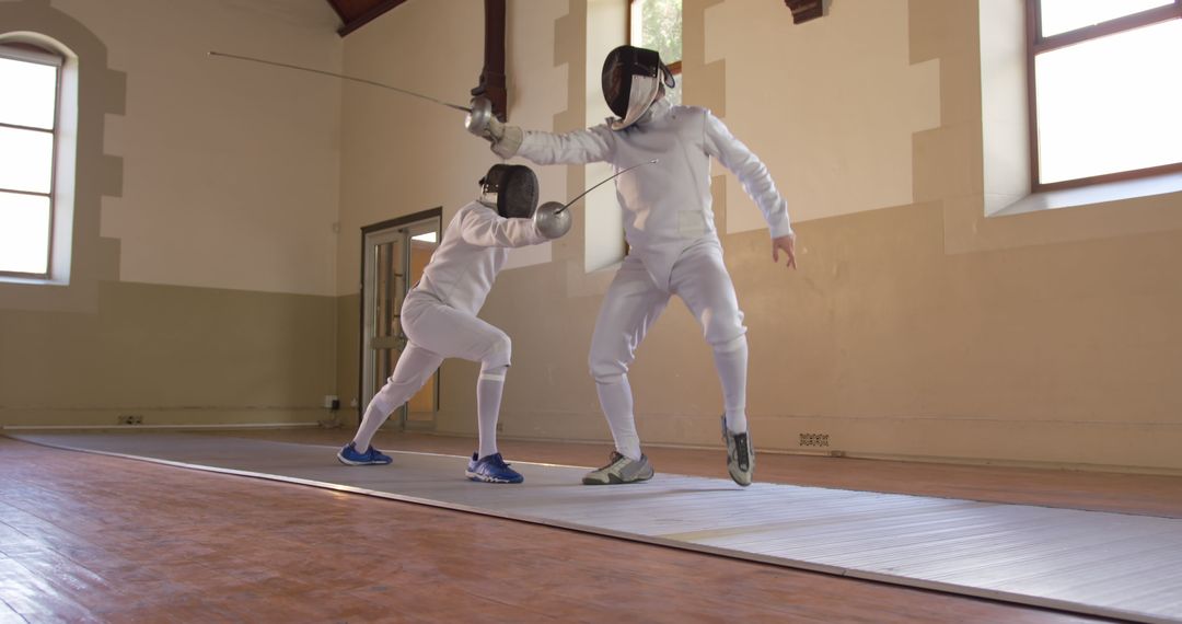 Fencers Sparring in Indoor Sports Facility - Free Images, Stock Photos and Pictures on Pikwizard.com