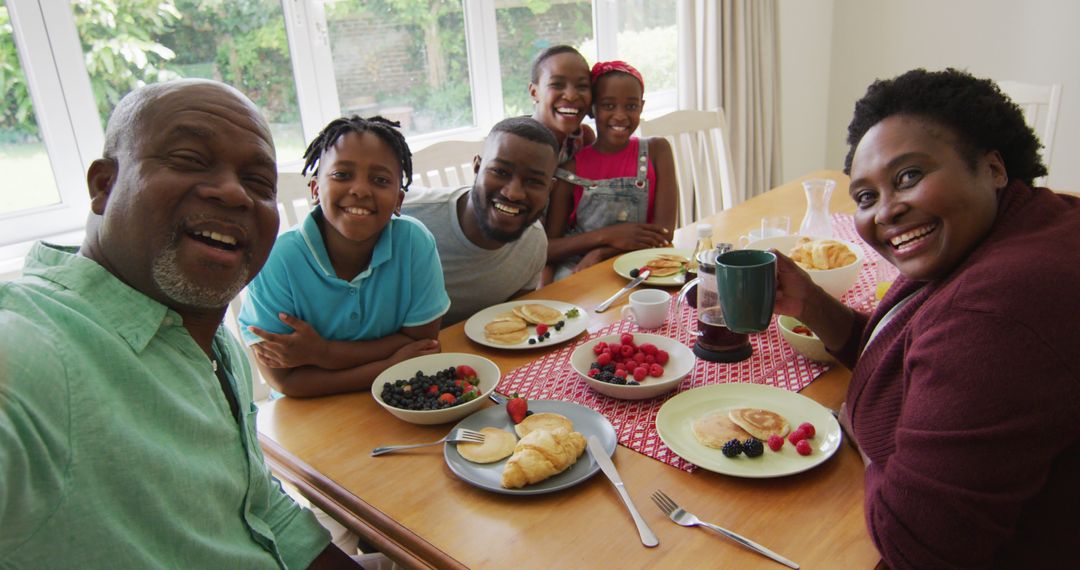 Three generation african american family taking a selfie while having breakfast together at home - Free Images, Stock Photos and Pictures on Pikwizard.com