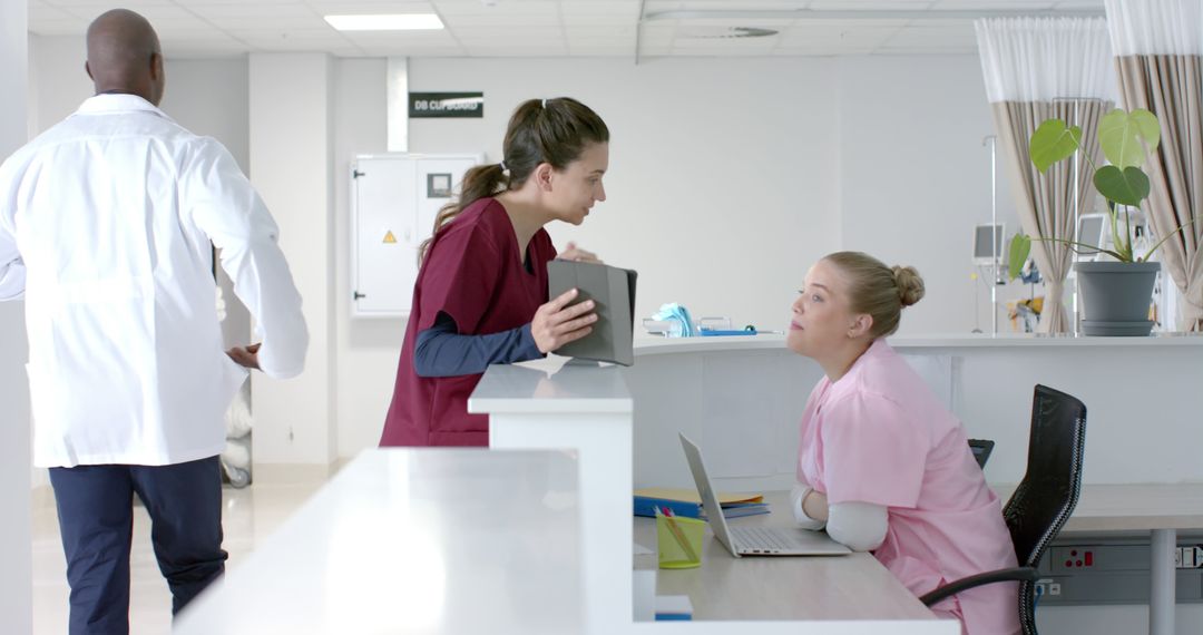 Medical Staff Interacting in a Modern Hospital - Free Images, Stock Photos and Pictures on Pikwizard.com