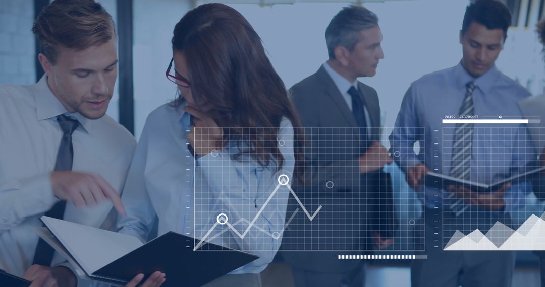 Diverse Business Team Analyzing Data Graphs in Office