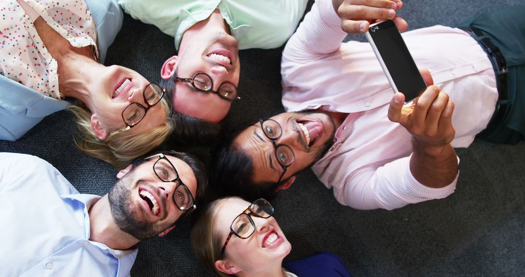 Team of Colleagues Laying on Floor Taking a Selfie, Top View - Free Images, Stock Photos and Pictures on Pikwizard.com