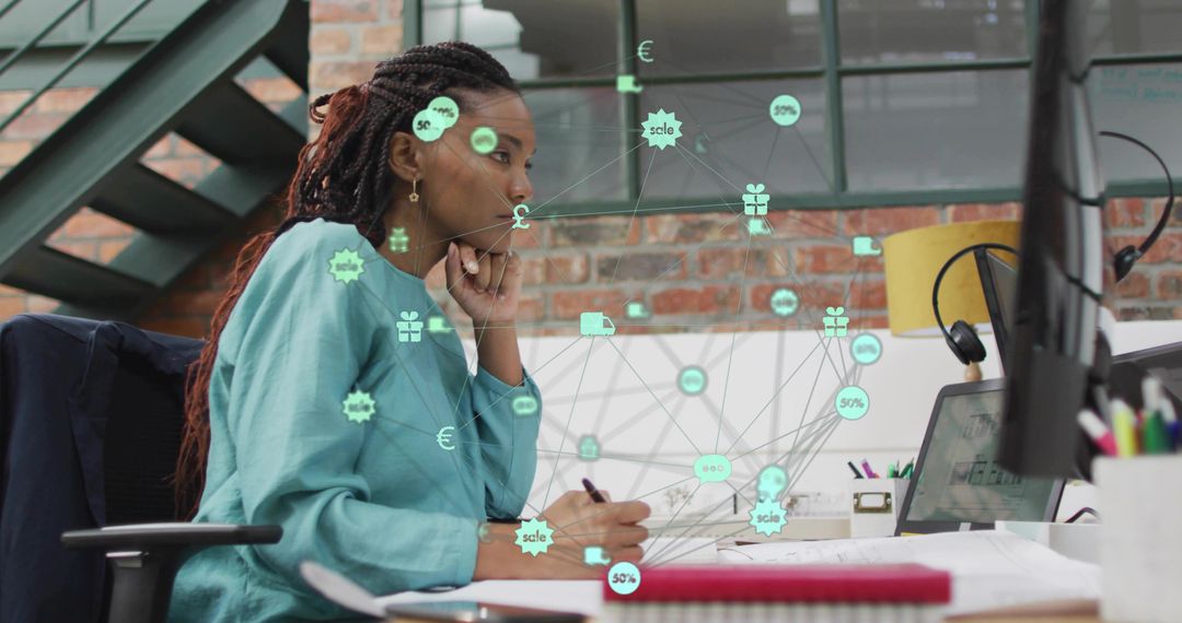 Creative professional analyzing network data overlays on monitor in modern loft workspace