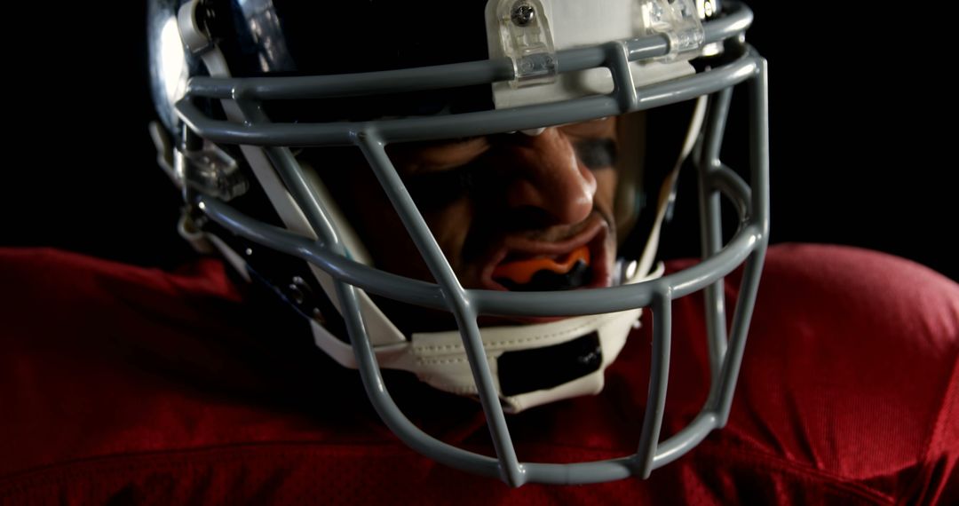 Determined American Football Player in Helmet Focusing Ahead - Free Images, Stock Photos and Pictures on Pikwizard.com