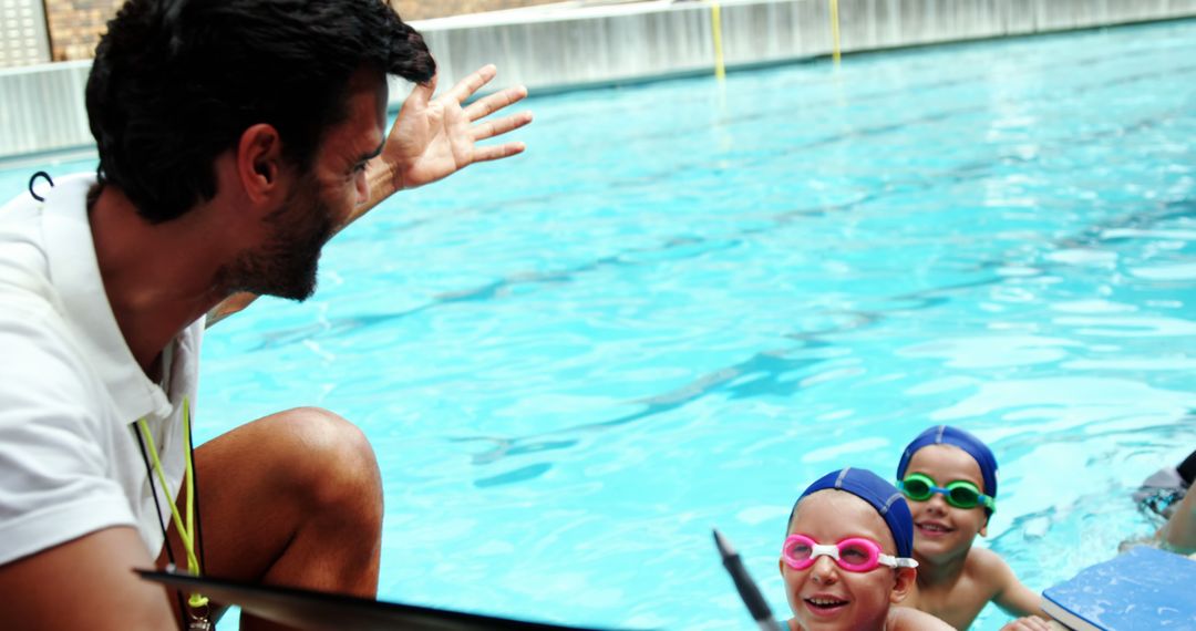 Swim Instructor Teaching Young Children in Pool - Free Images, Stock Photos and Pictures on Pikwizard.com