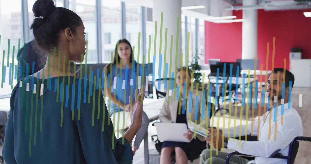 Female Leader Presenting Data to Diverse Office Team