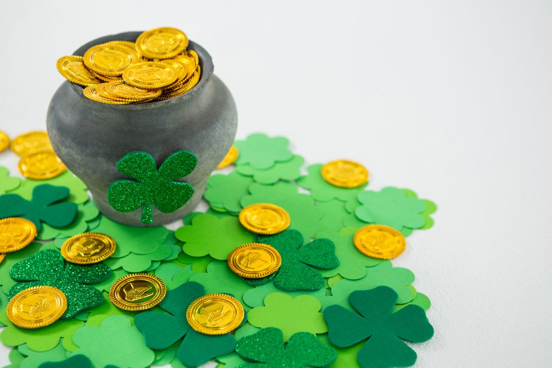 St. Patricks Day shamrocks and pot filled with chocolate gold coins - Free Images, Stock Photos and Pictures on Pikwizard.com