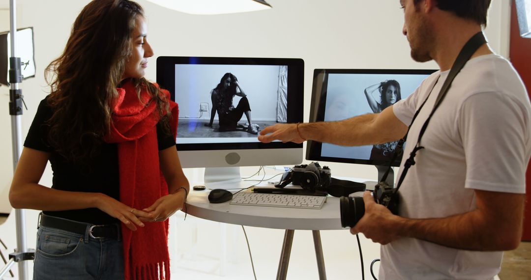 Photographer Discussing Portrait with Female Model in Studio - Free Images, Stock Photos and Pictures on Pikwizard.com