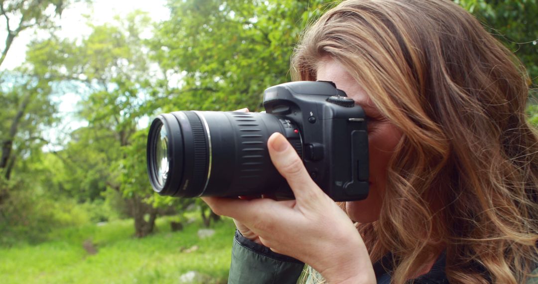 Female photographer capturing nature with digital camera in a forest - Free Images, Stock Photos and Pictures on Pikwizard.com