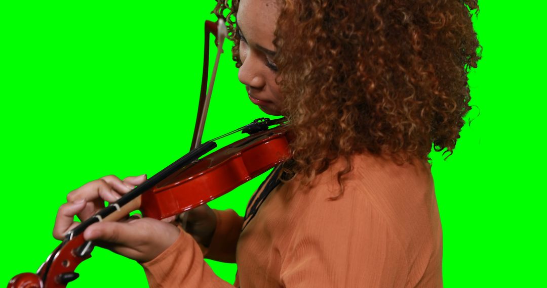 Curly Haired Woman Playing Violin on Green Screen Background - Free Images, Stock Photos and Pictures on Pikwizard.com