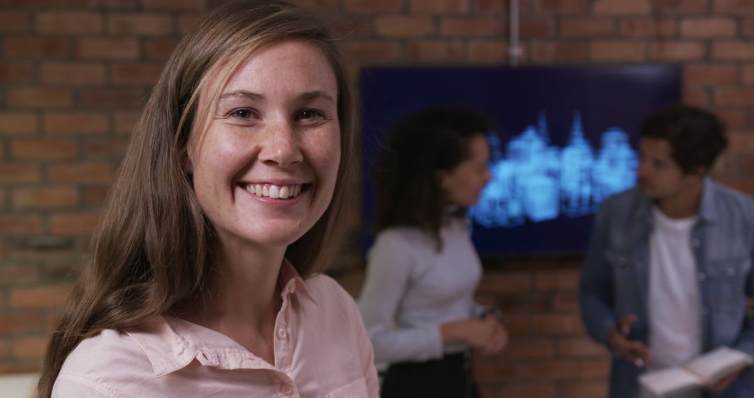 Smiling Businesswoman Standing in Modern Office During Team Meeting - Free Images, Stock Photos and Pictures on Pikwizard.com