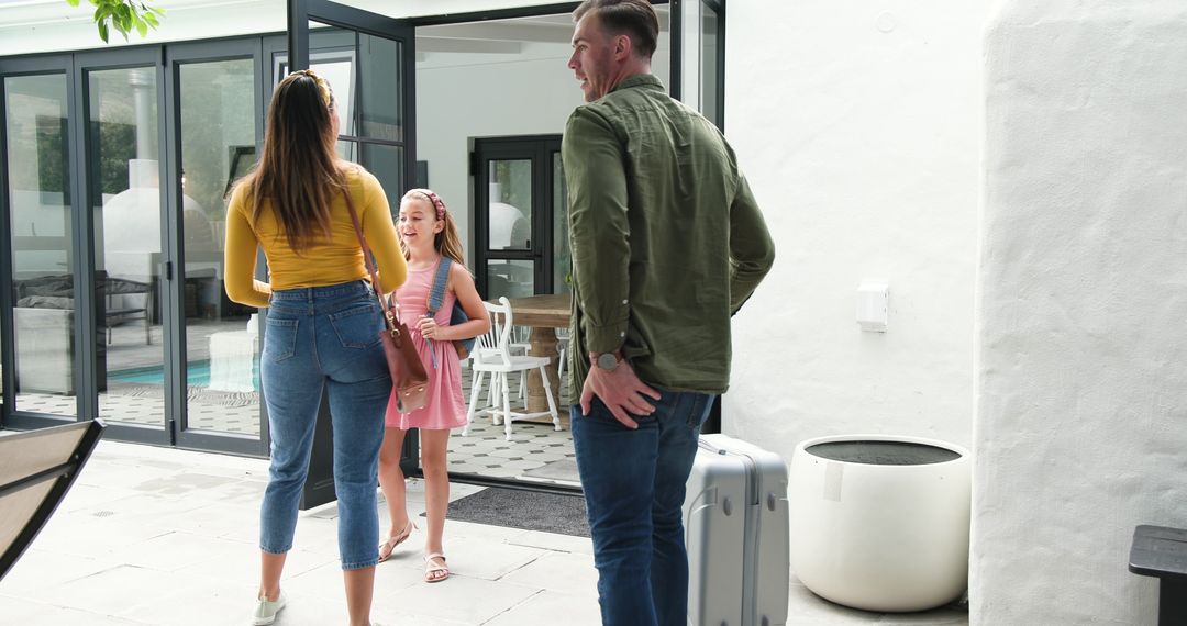 Happy Family Returning Home After Vacation, Embracing in Joyful Reunion
